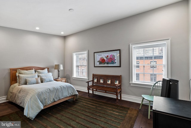 bedroom with multiple windows, baseboards, dark wood-type flooring, and recessed lighting