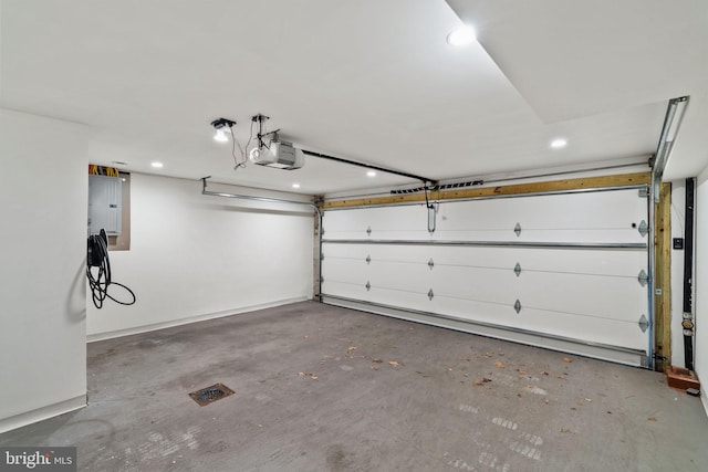 garage featuring electric panel and a garage door opener