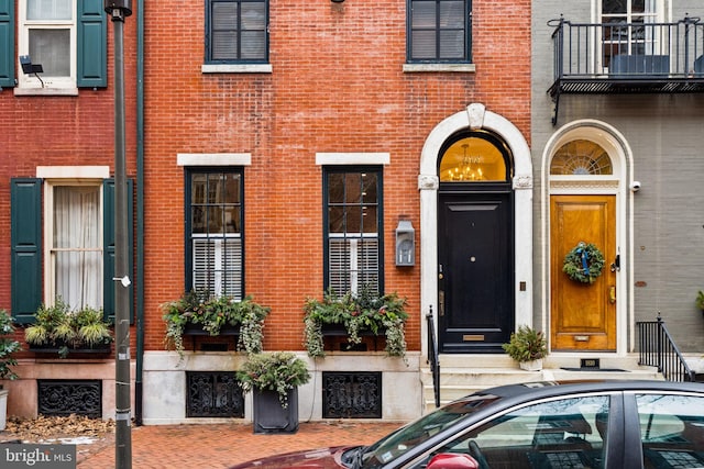 doorway to property featuring brick siding