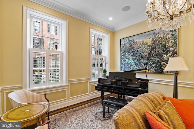 living area featuring a wainscoted wall, ornamental molding, and a wealth of natural light