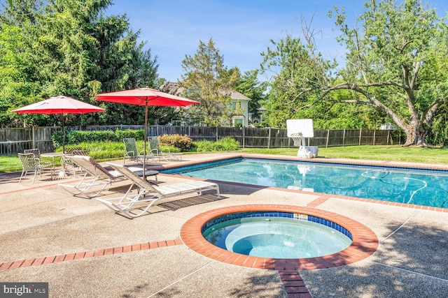 view of swimming pool with a fenced in pool, a patio, an in ground hot tub, and fence