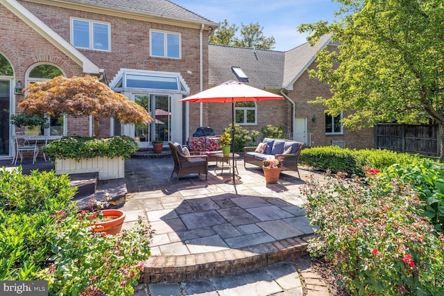 view of patio with an outdoor living space and fence