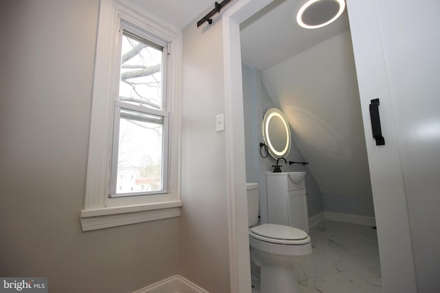 bathroom with vanity, toilet, and vaulted ceiling