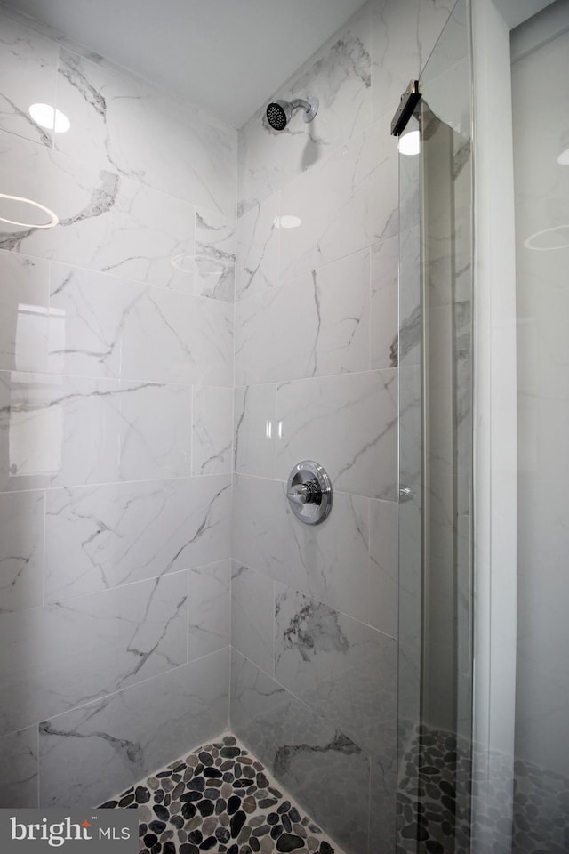 bathroom with a tile shower