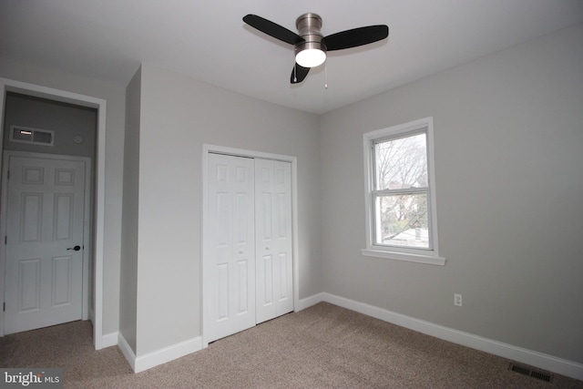 unfurnished bedroom with carpet flooring, ceiling fan, and a closet