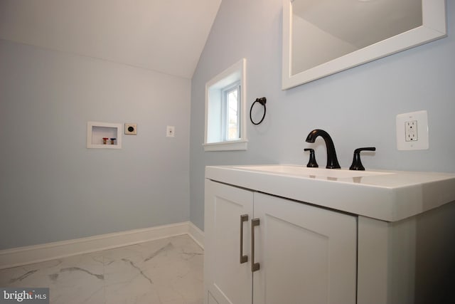 bathroom featuring vanity and lofted ceiling