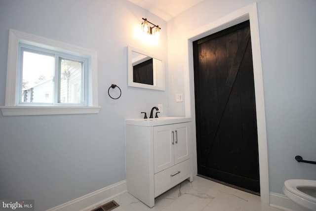 bathroom with vanity and toilet