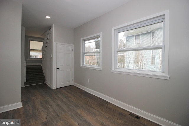 unfurnished room with dark hardwood / wood-style flooring