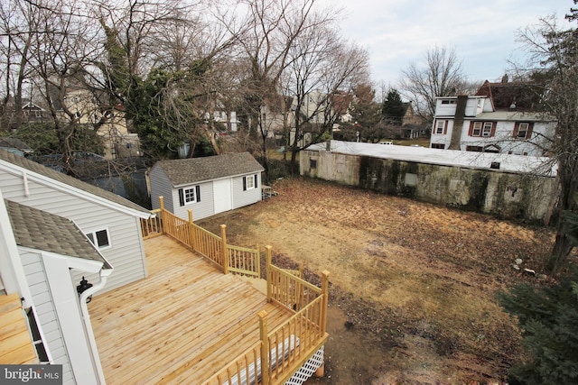 view of yard featuring a storage shed and a wooden deck