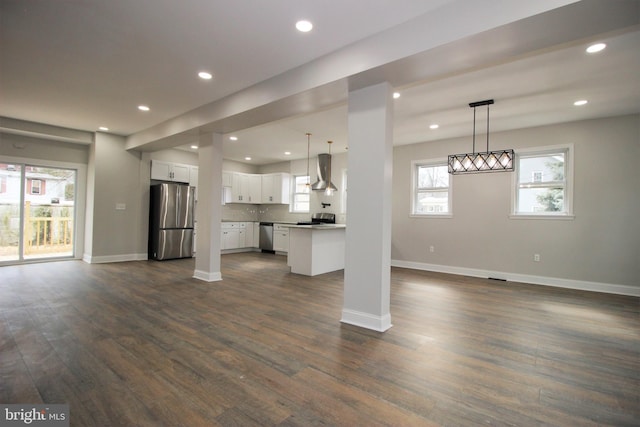 unfurnished living room with dark hardwood / wood-style flooring