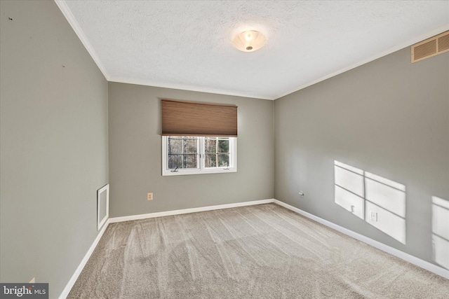 carpeted spare room with crown molding and a textured ceiling