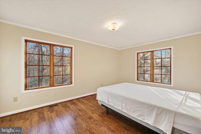 bedroom featuring dark hardwood / wood-style floors and ornamental molding