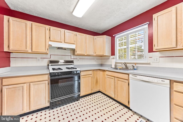 kitchen with light brown cabinetry, a textured ceiling, white dishwasher, sink, and black gas stove