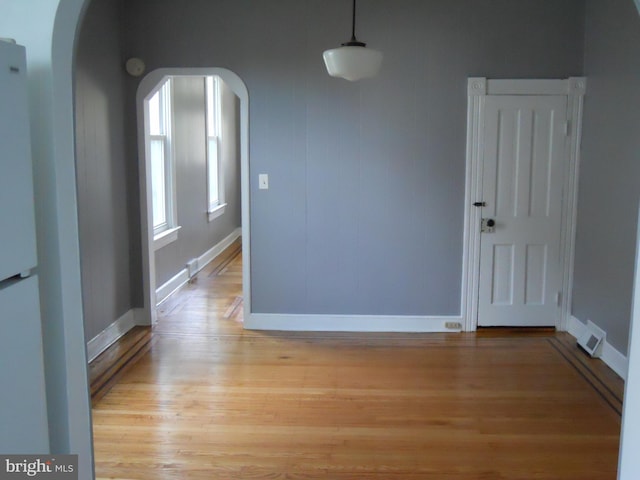 unfurnished dining area featuring light wood-type flooring