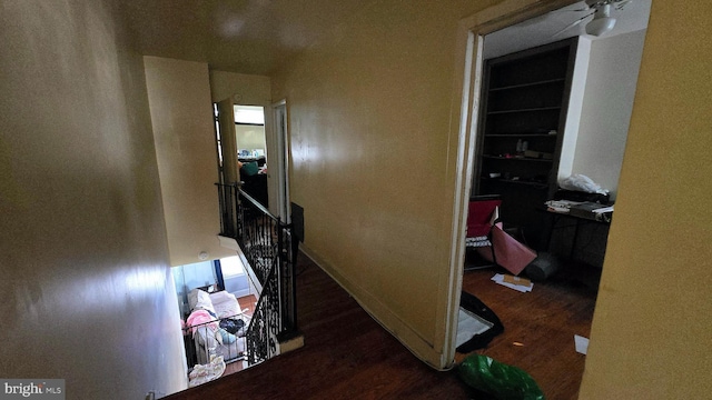 corridor with dark hardwood / wood-style flooring