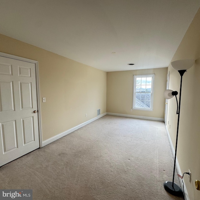 empty room featuring light colored carpet