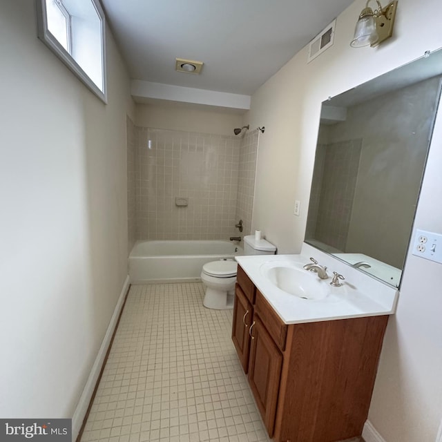 full bathroom with tiled shower / bath, vanity, and toilet