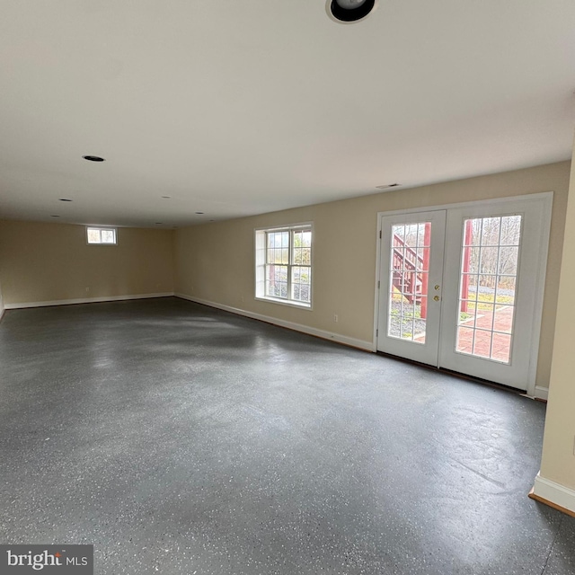 spare room with a wealth of natural light and french doors