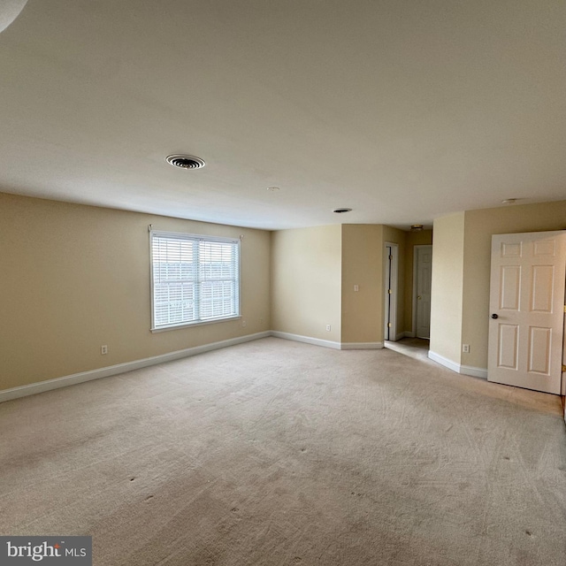 unfurnished room with light carpet