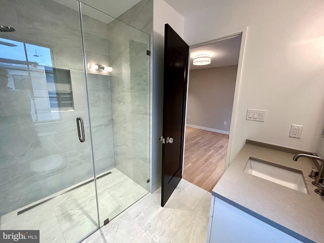 bathroom featuring vanity, hardwood / wood-style floors, and walk in shower