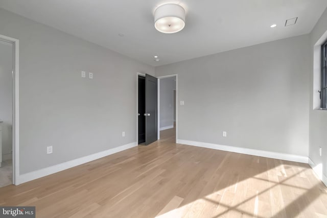 spare room featuring light hardwood / wood-style floors