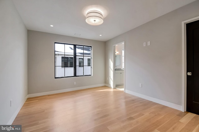 spare room with light hardwood / wood-style floors