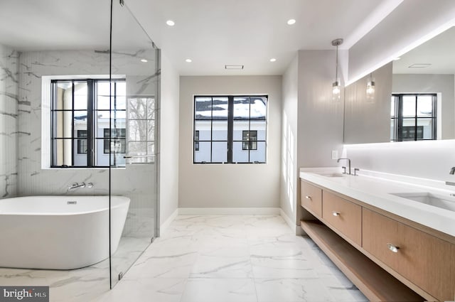 bathroom with a washtub and vanity