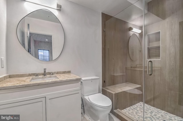 bathroom with vanity, toilet, and walk in shower