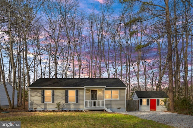 single story home with a yard and a storage shed