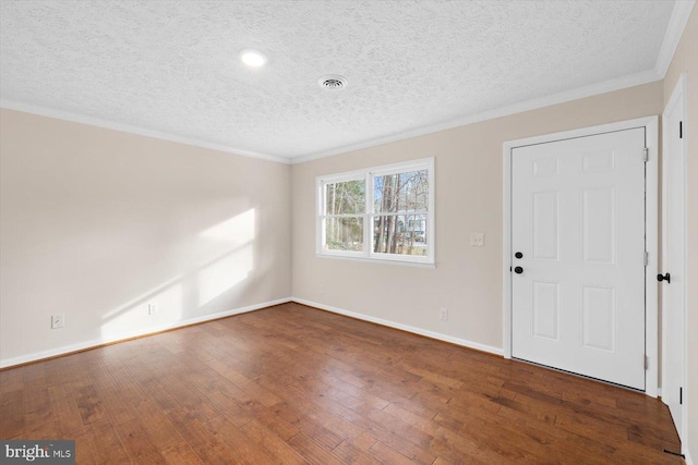 foyer featuring dark hardwood / wood-style flooring, ornamental molding, and a textured ceiling