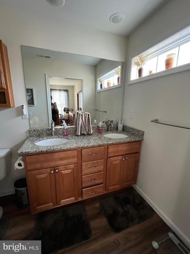 bathroom featuring hardwood / wood-style flooring, vanity, and toilet