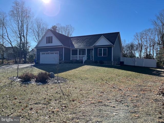 view of front of house with a porch, a front yard, and a garage