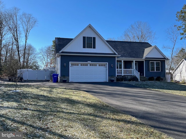 view of front of home with a porch and a garage