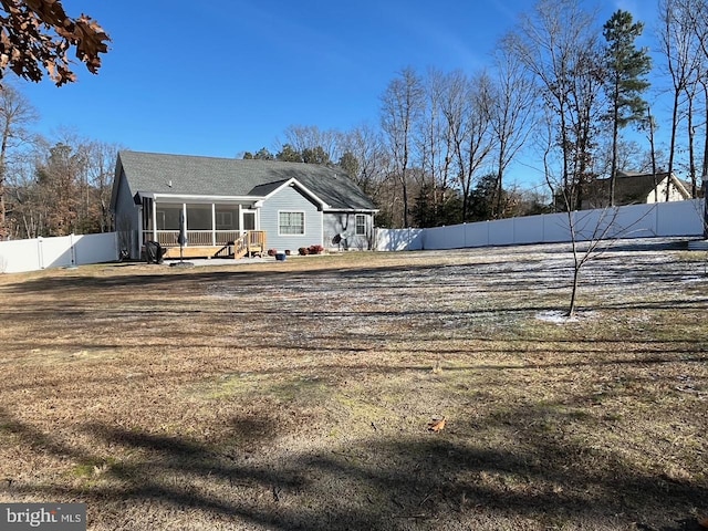 rear view of property with a sunroom