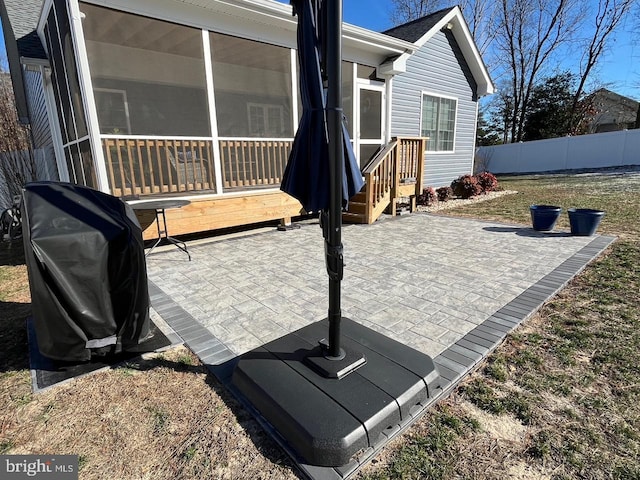 view of patio with grilling area and a sunroom