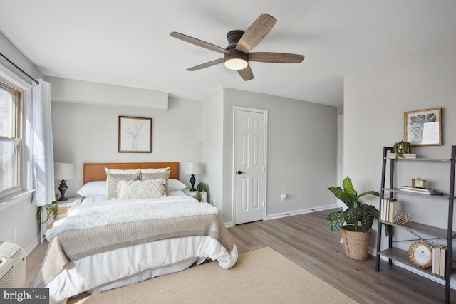 bedroom with ceiling fan and wood-type flooring