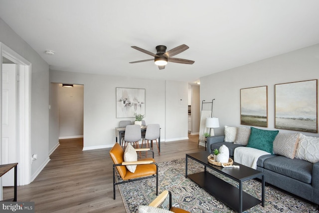 living room featuring wood-type flooring and ceiling fan