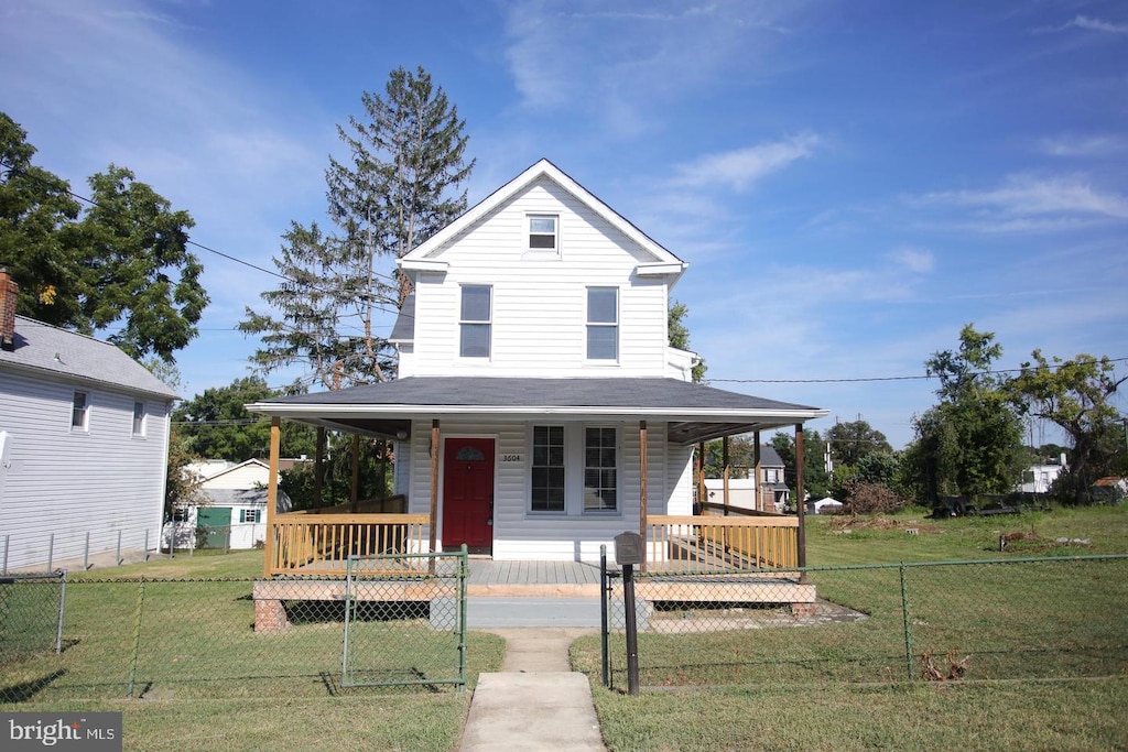 country-style home featuring covered porch and a front yard