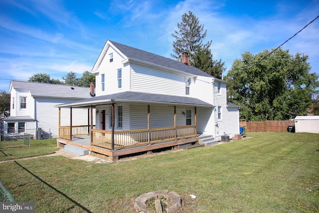 back of house with a lawn