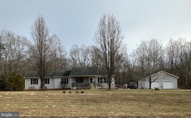 ranch-style home with an outbuilding, a porch, a garage, and a front lawn