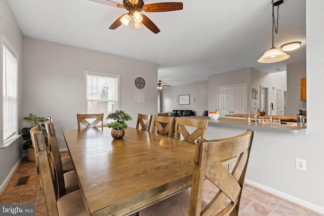 dining room featuring ceiling fan and plenty of natural light