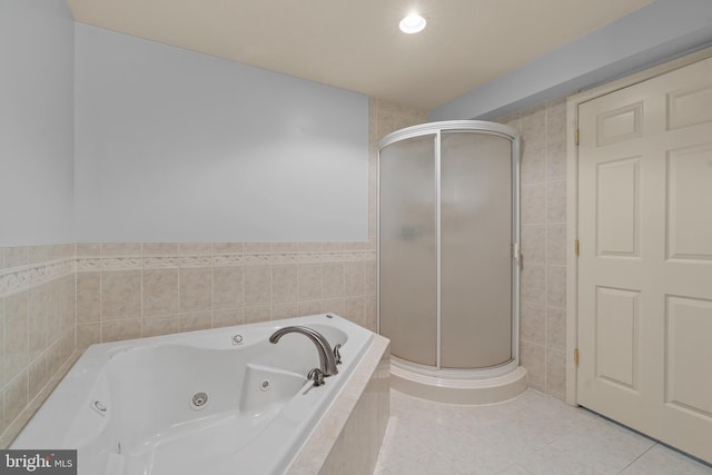 bathroom with tile patterned flooring and shower with separate bathtub