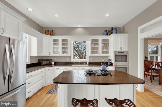 kitchen featuring sink, white cabinetry, a center island, and stainless steel appliances