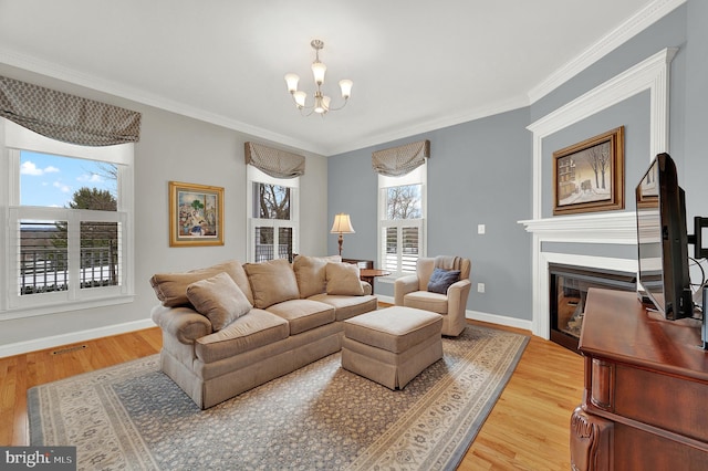 living room featuring plenty of natural light, crown molding, and hardwood / wood-style flooring