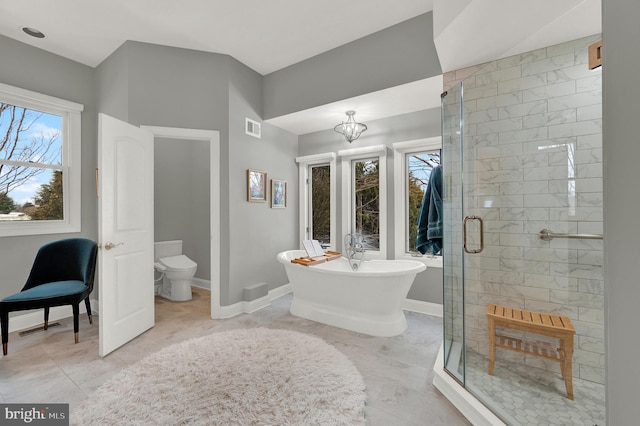 bathroom with separate shower and tub, plenty of natural light, toilet, and a notable chandelier