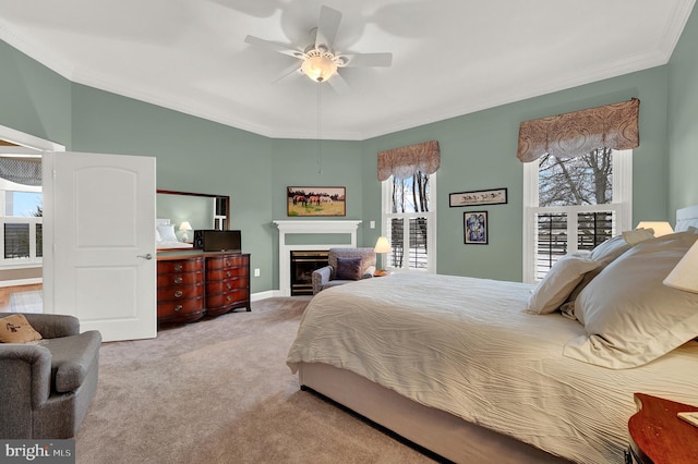 bedroom featuring ceiling fan, ornamental molding, and light carpet