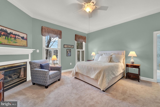 carpeted bedroom with ceiling fan and ornamental molding