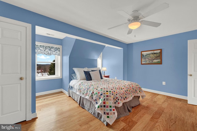 bedroom with ceiling fan and light hardwood / wood-style floors