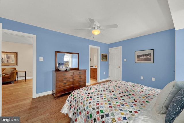 bedroom featuring ceiling fan, ensuite bathroom, and hardwood / wood-style flooring