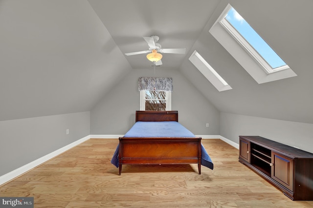 bedroom with ceiling fan, light hardwood / wood-style flooring, and vaulted ceiling